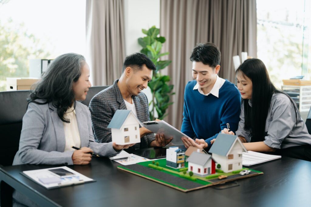 A family couple sign a lease meeting with a realtor or homeowner, purchase the first mortgage